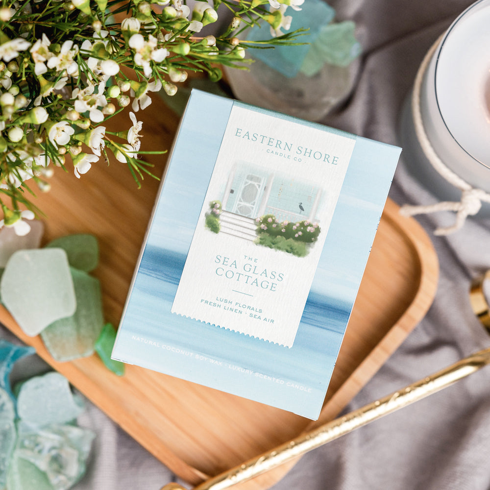 The Sea Glass Cottage candle box  - coconut soy wax candle - cottage garden scent, seaside garden, geranium, jasmine, gardenia, roses, lily, magnolia, peony, seaside air, sea breeze, Scented candle, coastal candle, eastern shore, Chesapeake Bay, luxury candle, hand-poured, Maryland, Virginia, 10 oz candle box on a wooden tray